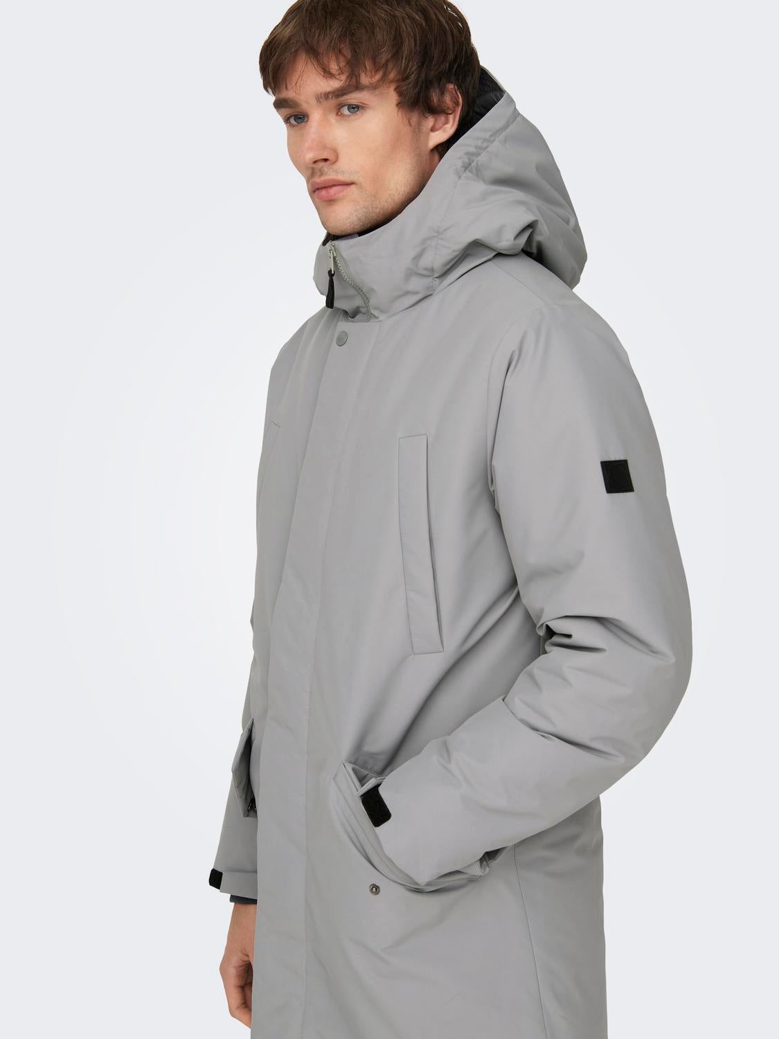 Hood with string regulation Elasticated cuffs Parka